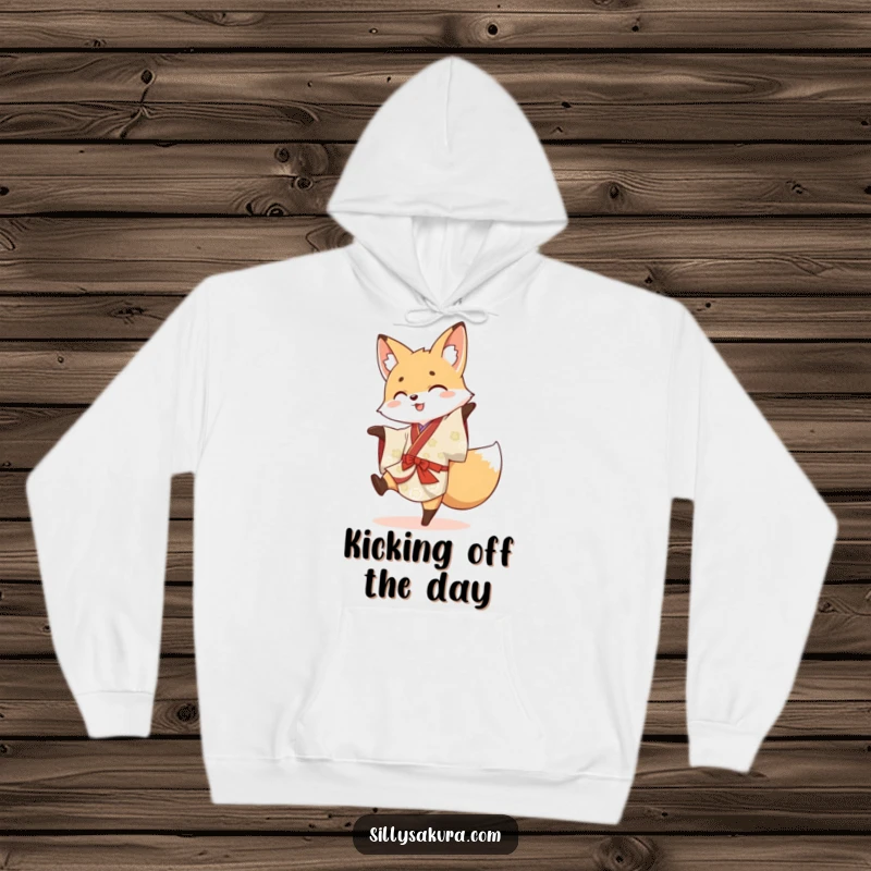Funny hoodie with a cheerful fox in a traditional kimono attempting a gymnastic cartwheel with a playful expression.