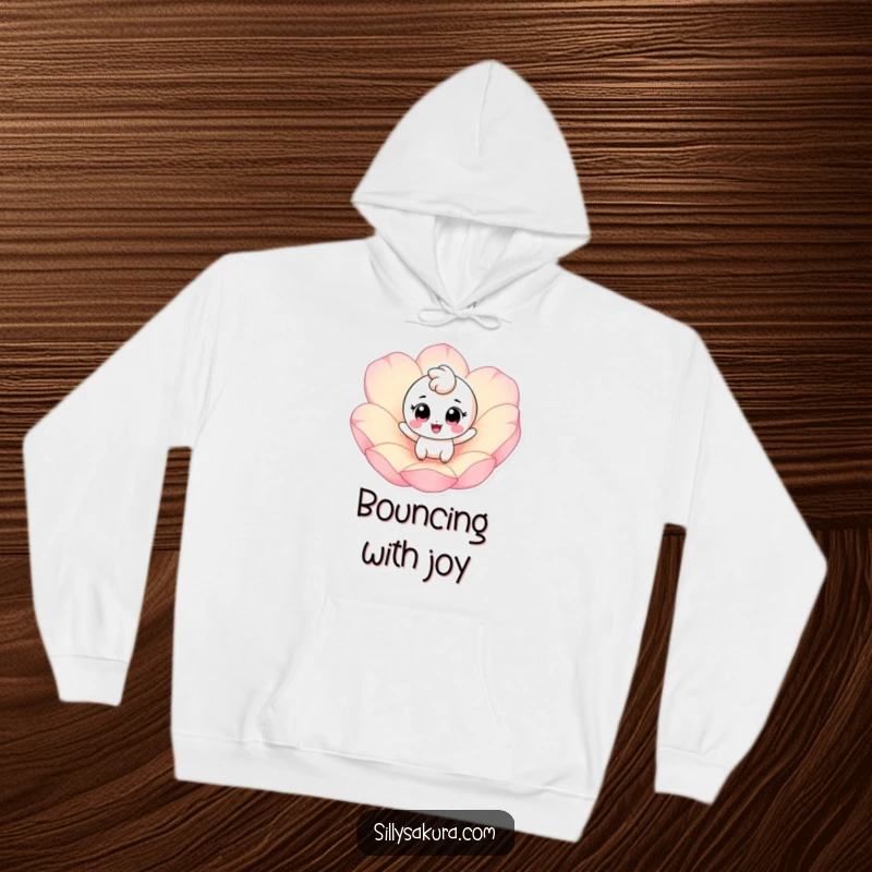 Funny hoodie with a cheerful, big-eyed character energetically bouncing on a giant pink petal, offering cozy, happy vibes.
