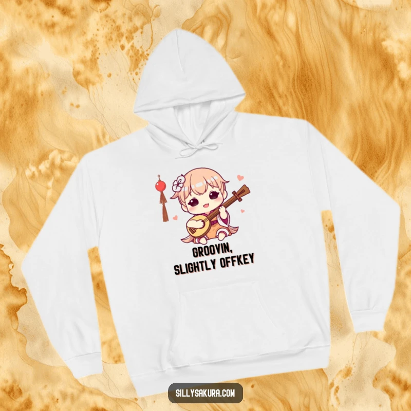 Funny Kawaii Hoodie. A cute character happily plays a small traditional instrument, perfect for staying warm and musical.