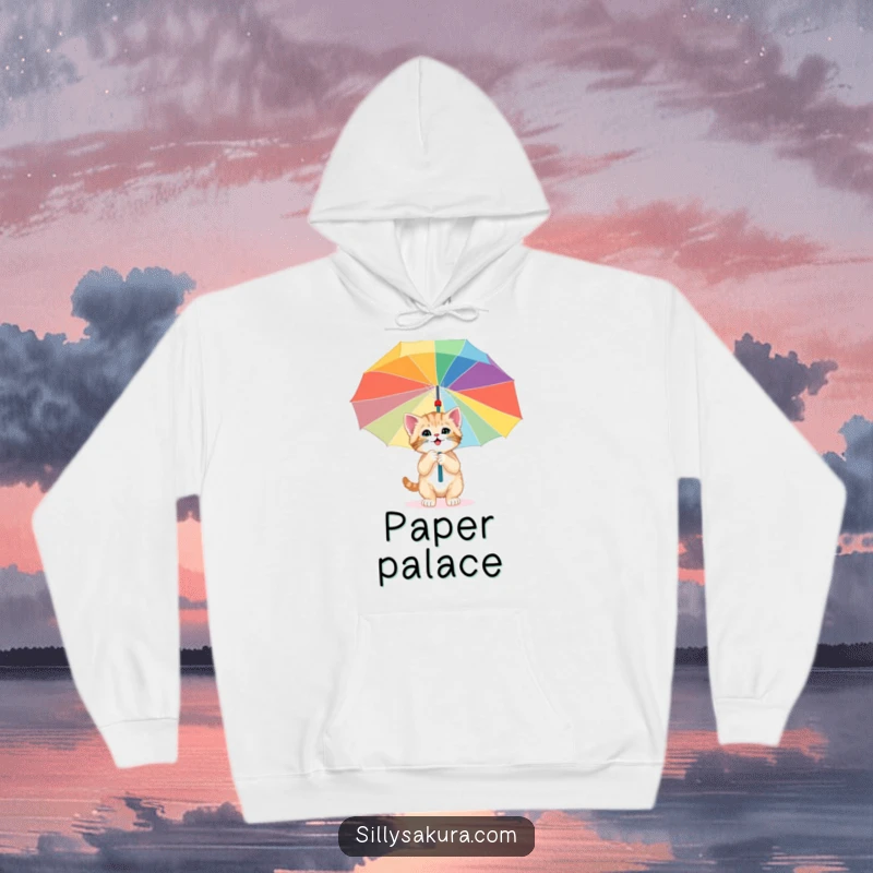 Funny hoodie featuring a happy kitten exploring under a giant, colorful paper umbrella, symbolizing cozy adventures and feline wonder.