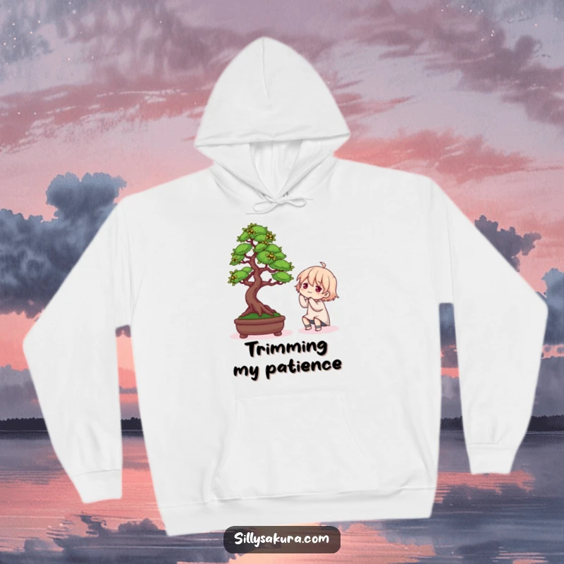 Funny hoodie featuring a character in a humorous pose while arranging a delicate Bonsai tree, ideal for plant lovers.