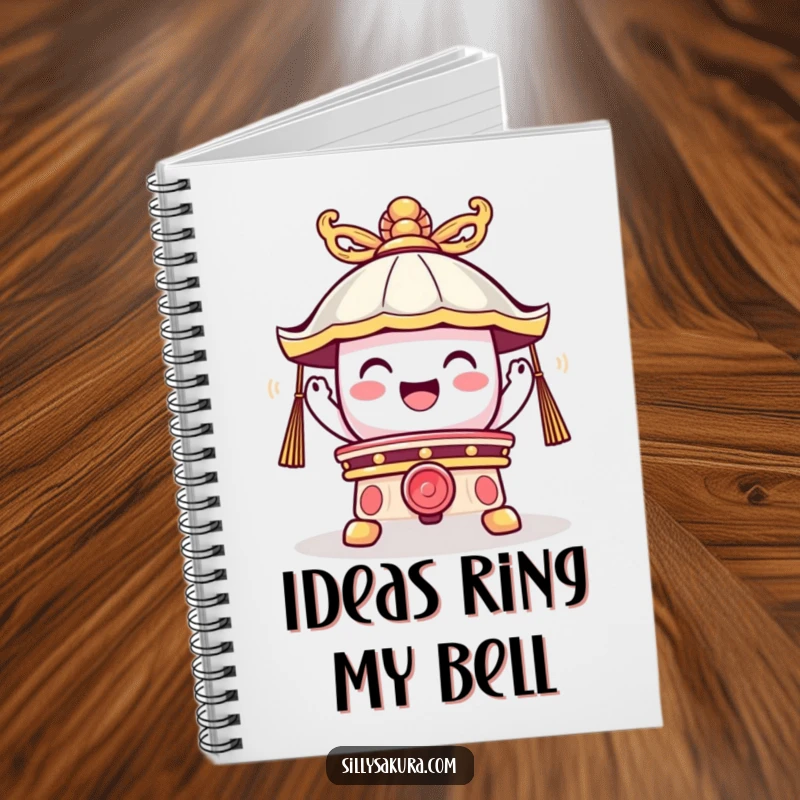 Funny notebook with a cute temple bell character ringing joyfully on the cover, perfect for jotting down happy thoughts and ideas.