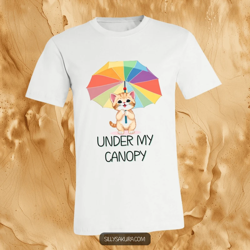 Funny t-shirt depicting a happy kitten curiously exploring under a large, vibrant paper umbrella, representing playful curiosity and grand adventures.